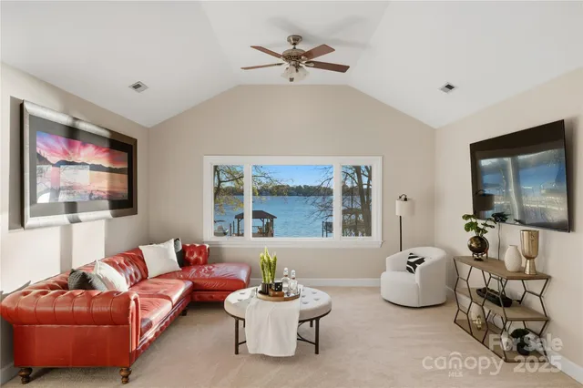 a living room with furniture gym equipment and a large window