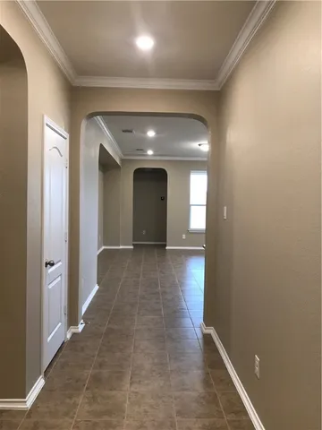 wooden floor with a chandelier