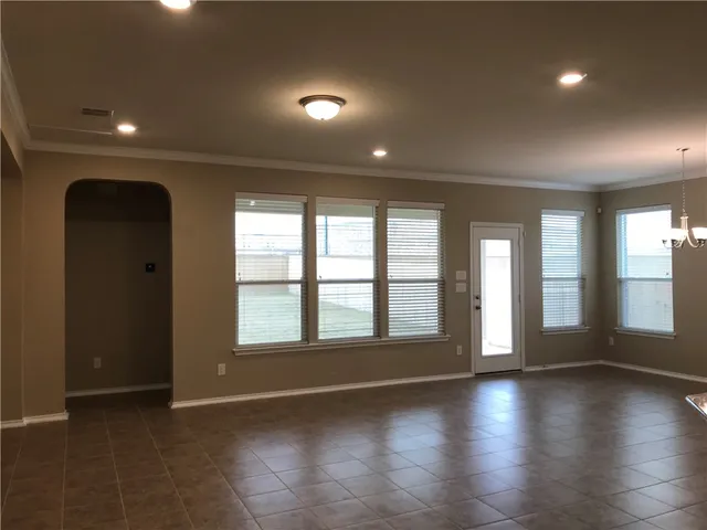 an empty room with floor to ceiling windows and yard