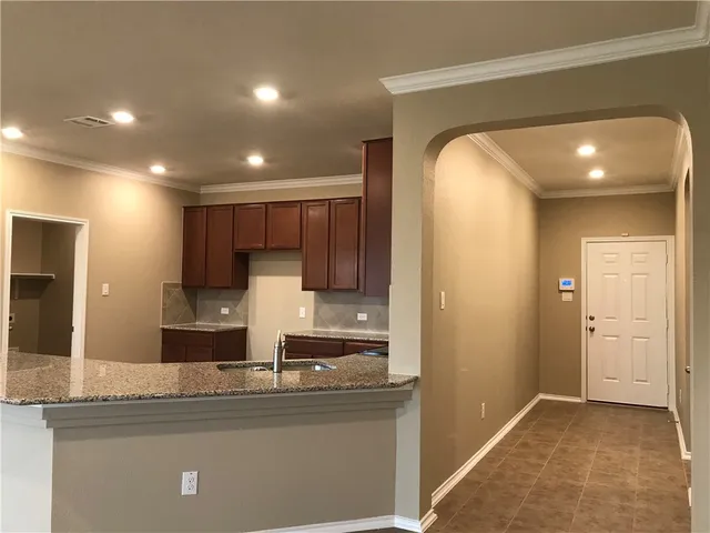 a kitchen with stainless steel appliances granite countertop a sink and cabinets