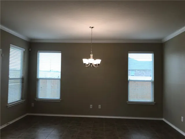a room with a window and a ceiling fan