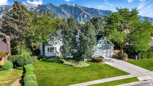 8965 Quail Run Drive Sandy, UT 84093 - Photo 8 of 56 View of front of property featuring a mountain view, driveway, and a front lawn