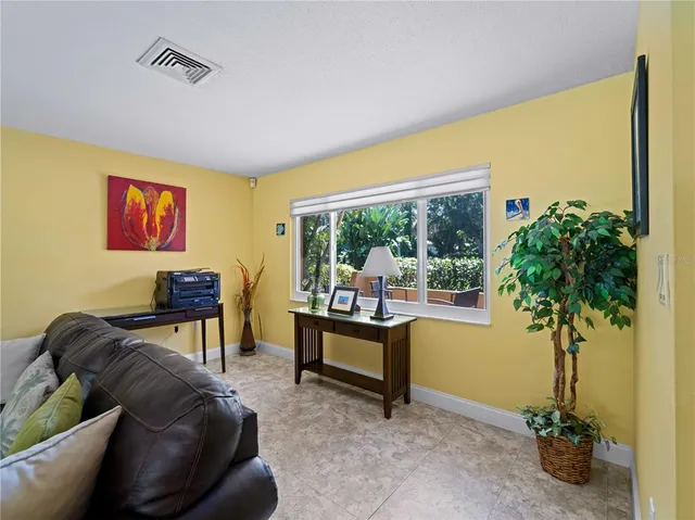 a living room with furniture and a potted plant