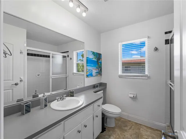 a view of a hallway to a livingroom with furniture and chandelier fan