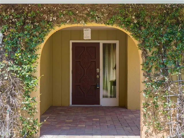 an entrance view of a house with a yard