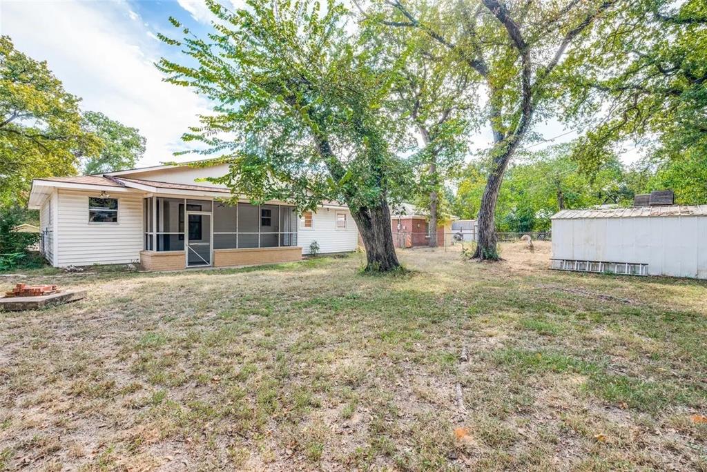 529 Roberts Cut Off Road River Oaks, TX 76114 - Photo 12 of 12 Back of house with a sunroom and a storage shed