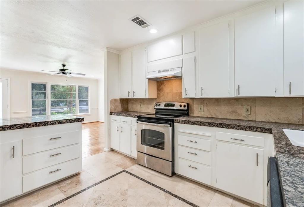529 Roberts Cut Off Road River Oaks, TX 76114 - Photo 4 of 12 Kitchen featuring stainless steel electric stove, white cabinetry, recessed lighting, tile counters, and ceiling fan
