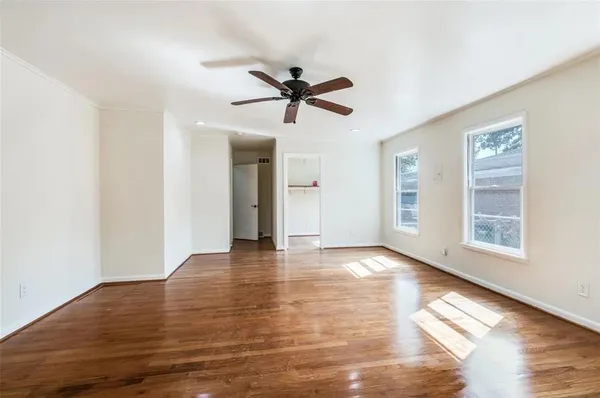a view of a livingroom with a window and wooden floor