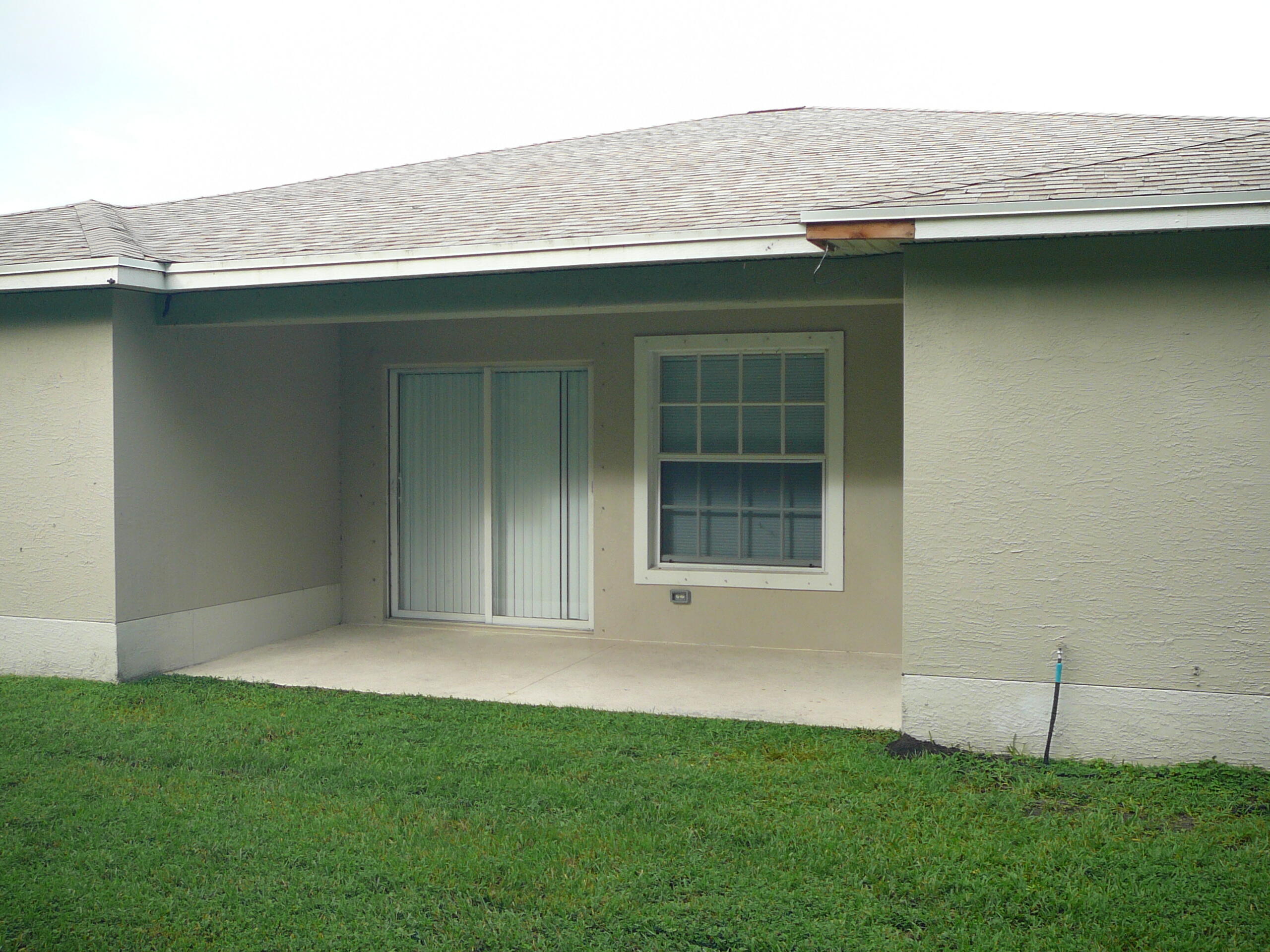 6512 Las Palmas Way Port St. Lucie, FL 34952 - Photo 12 of 45 a front view of a house with a yard