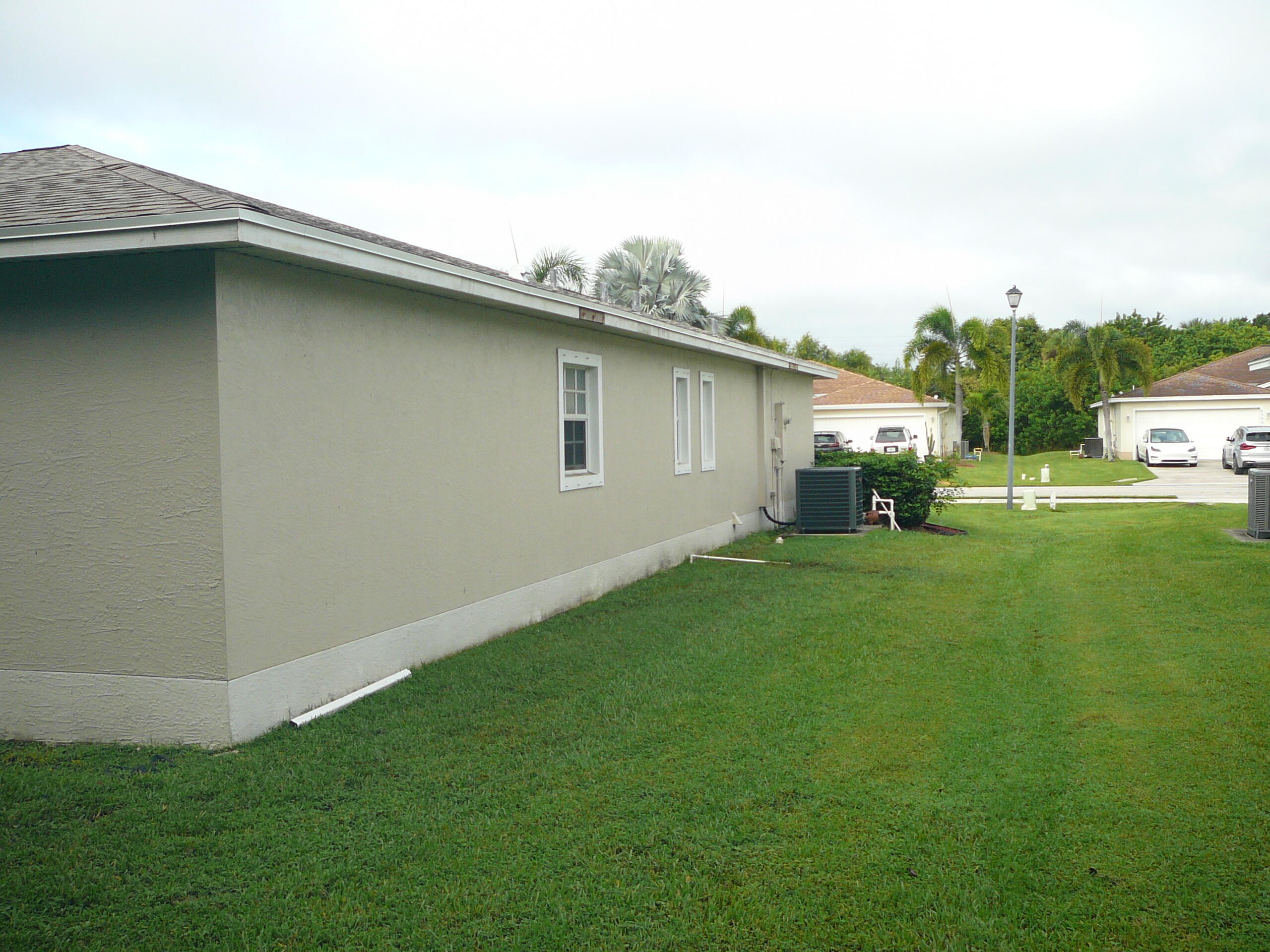 6512 Las Palmas Way Port St. Lucie, FL 34952 - Photo 14 of 45 a backyard of a house with table and chairs