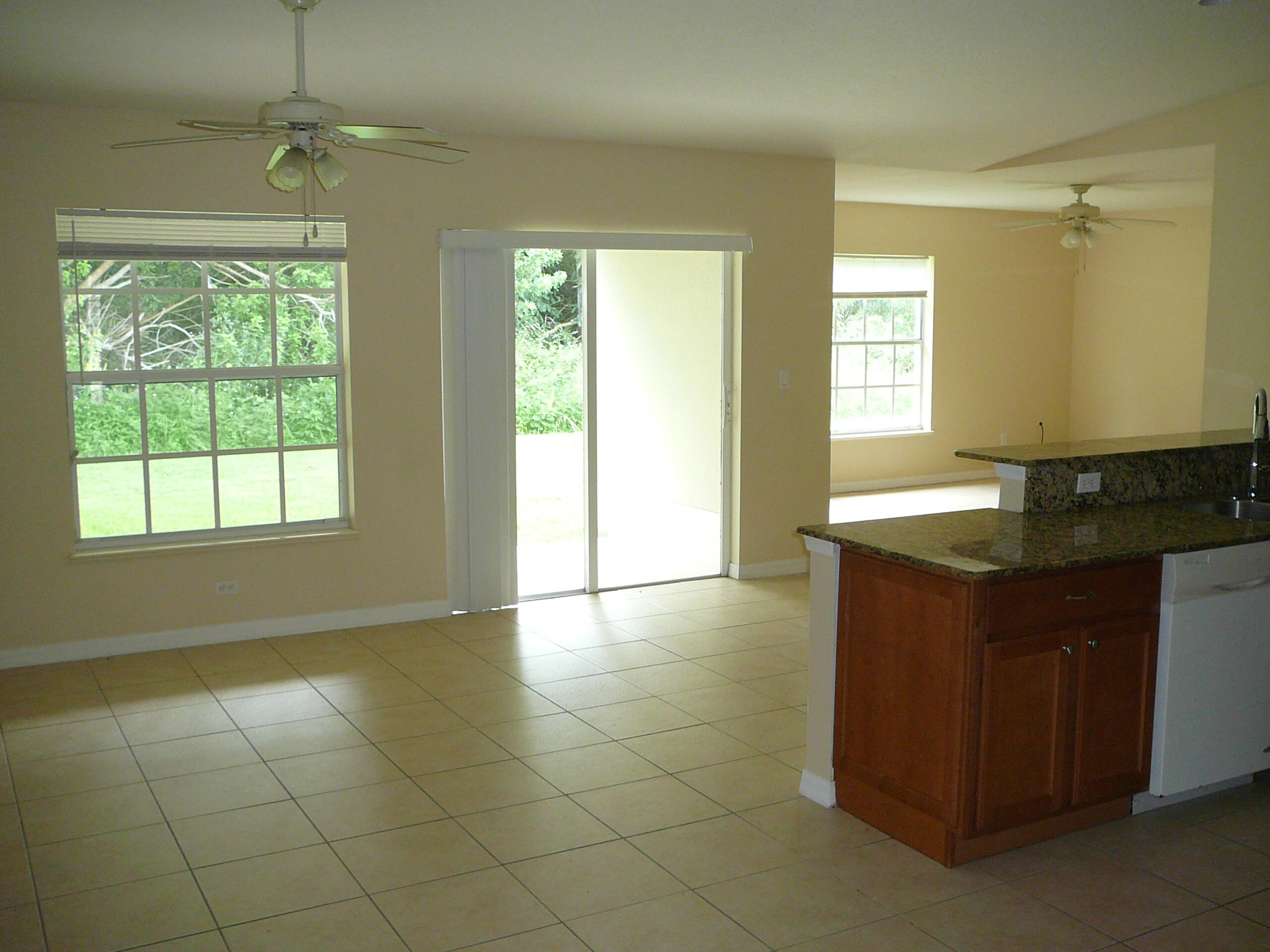 6512 Las Palmas Way Port St. Lucie, FL 34952 - Photo 19 of 45 a kitchen with granite countertop a sink and a stove