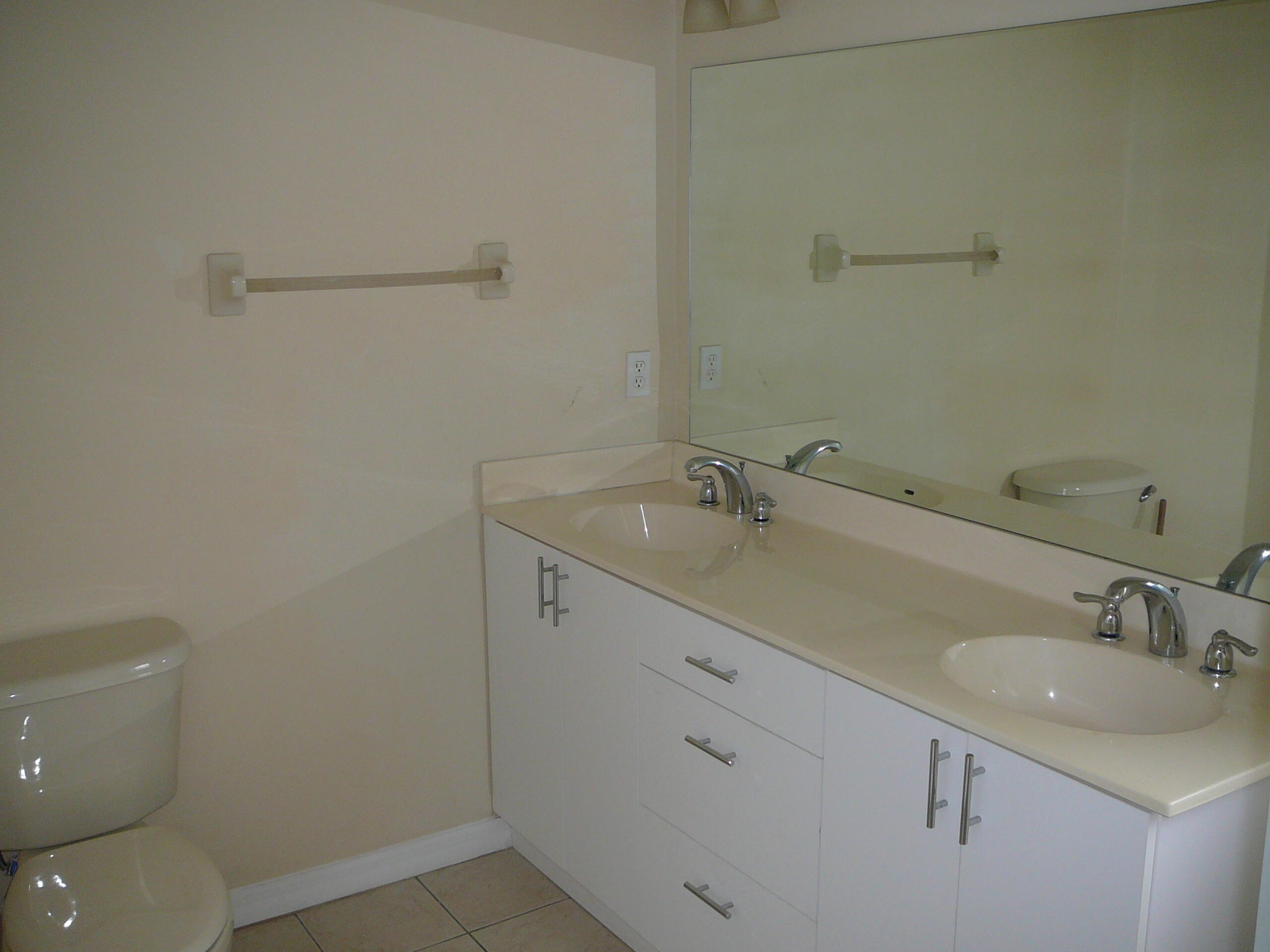6512 Las Palmas Way Port St. Lucie, FL 34952 - Photo 33 of 45 a bathroom with a sink toilet and vanity