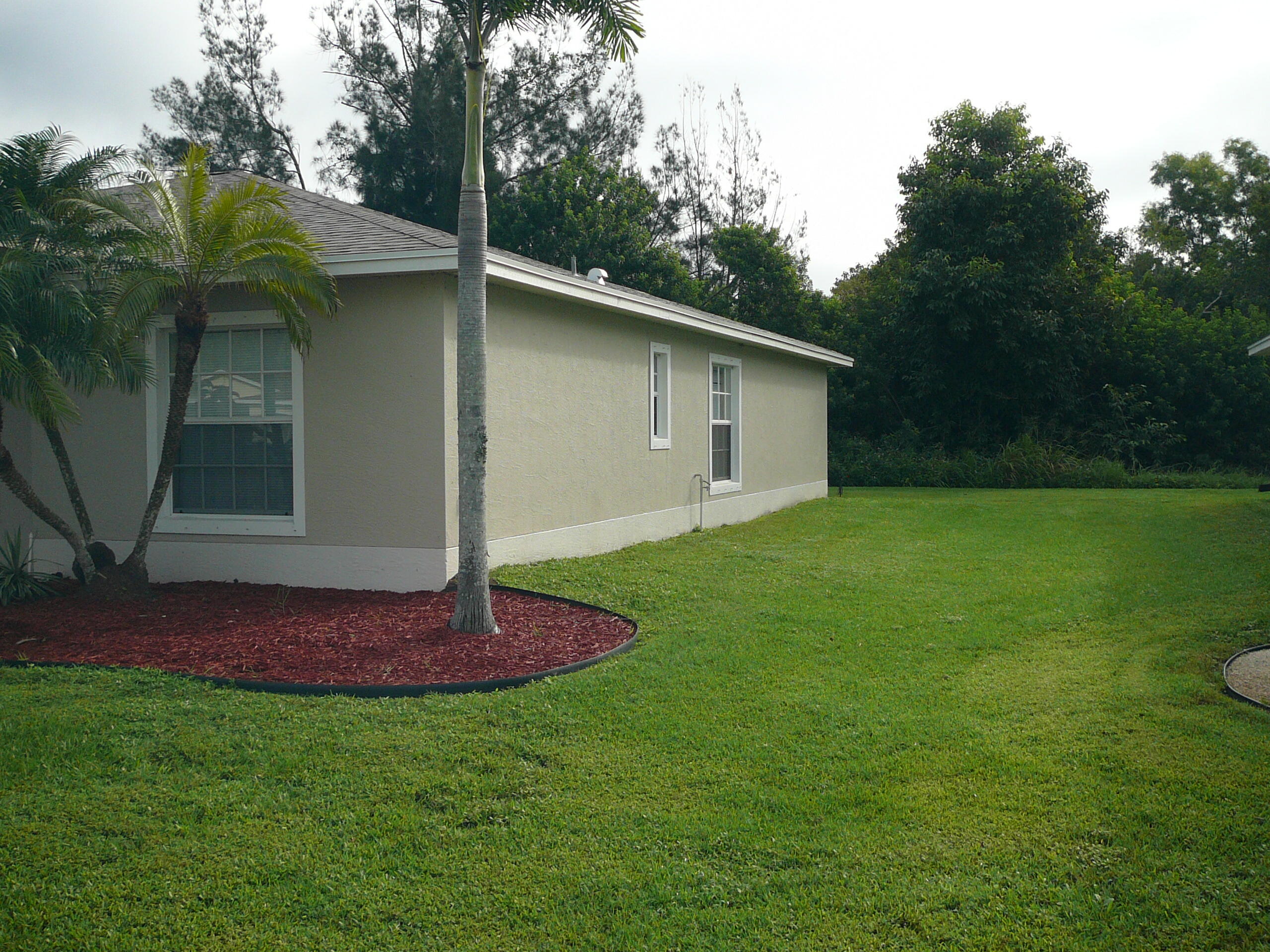 6512 Las Palmas Way Port St. Lucie, FL 34952 - Photo 4 of 45 a backyard of a house with lots of green space