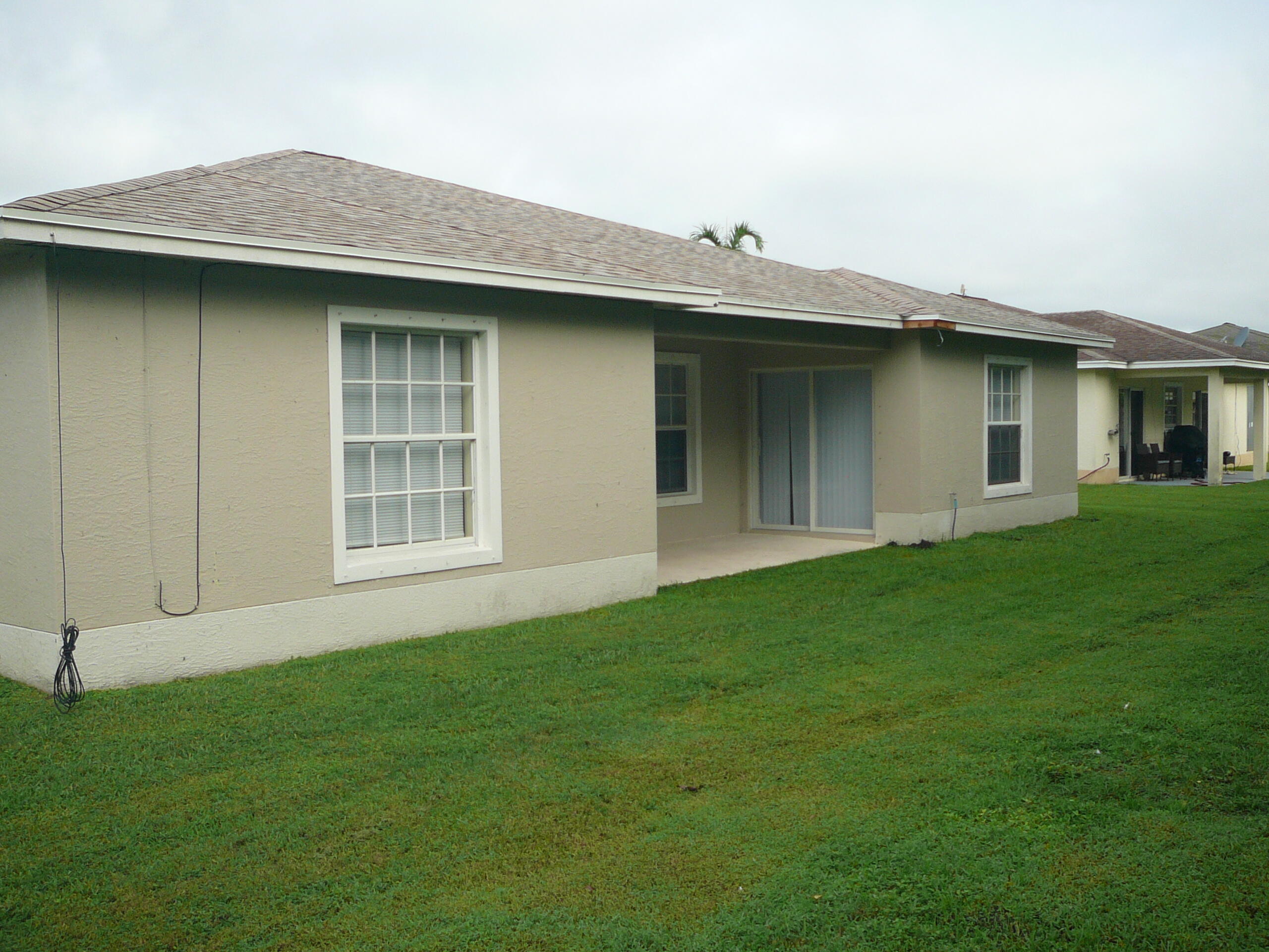 6512 Las Palmas Way Port St. Lucie, FL 34952 - Photo 10 of 45 a view of outdoor space yard and front view of a house
