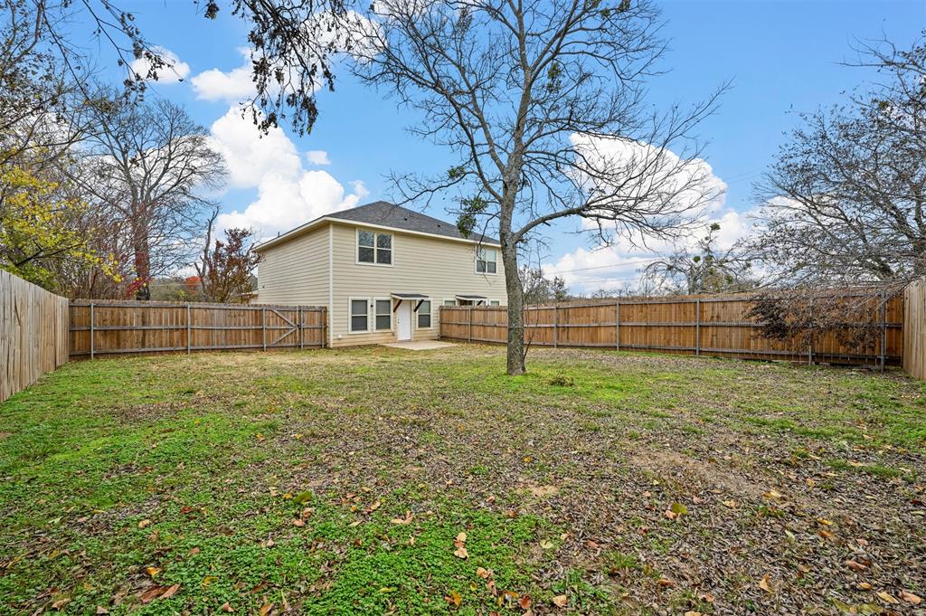 601 Thomas Street, Unit 1 Bonham, TX 75418 - Photo 18 of 23 a view of a backyard with a garden