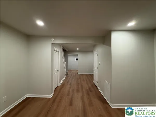 a view of hallway with wooden floor