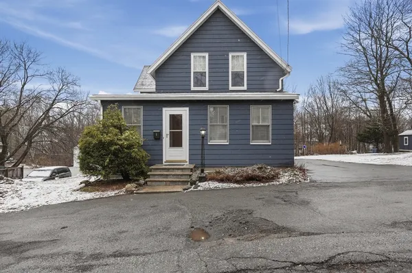 a view of a house with a yard covered with snow