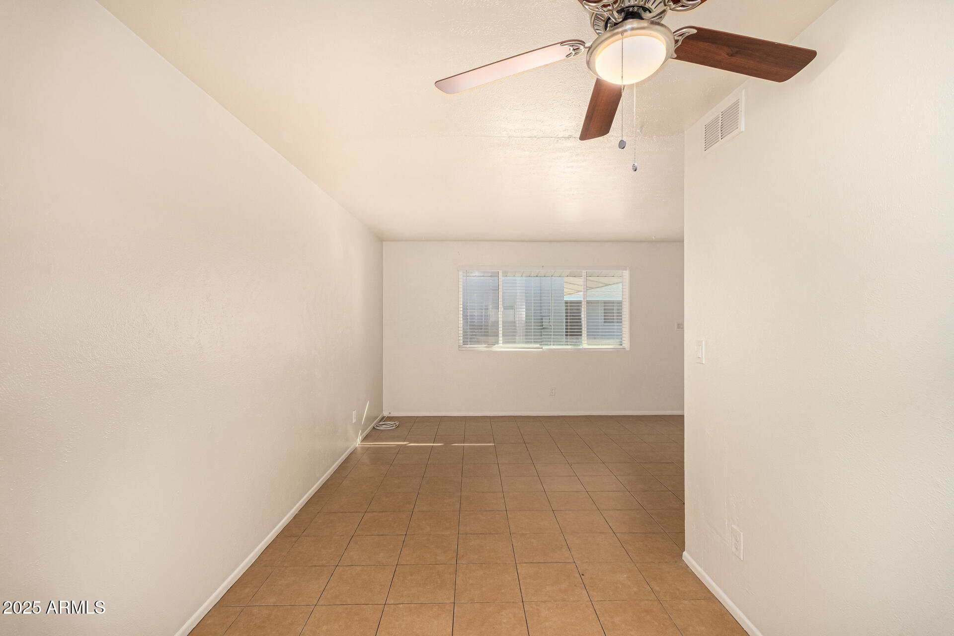 1204 West 5th Street, Unit 8 Tempe, AZ 85281 - Photo 5 of 18 a view of a room with a ceiling fan and window