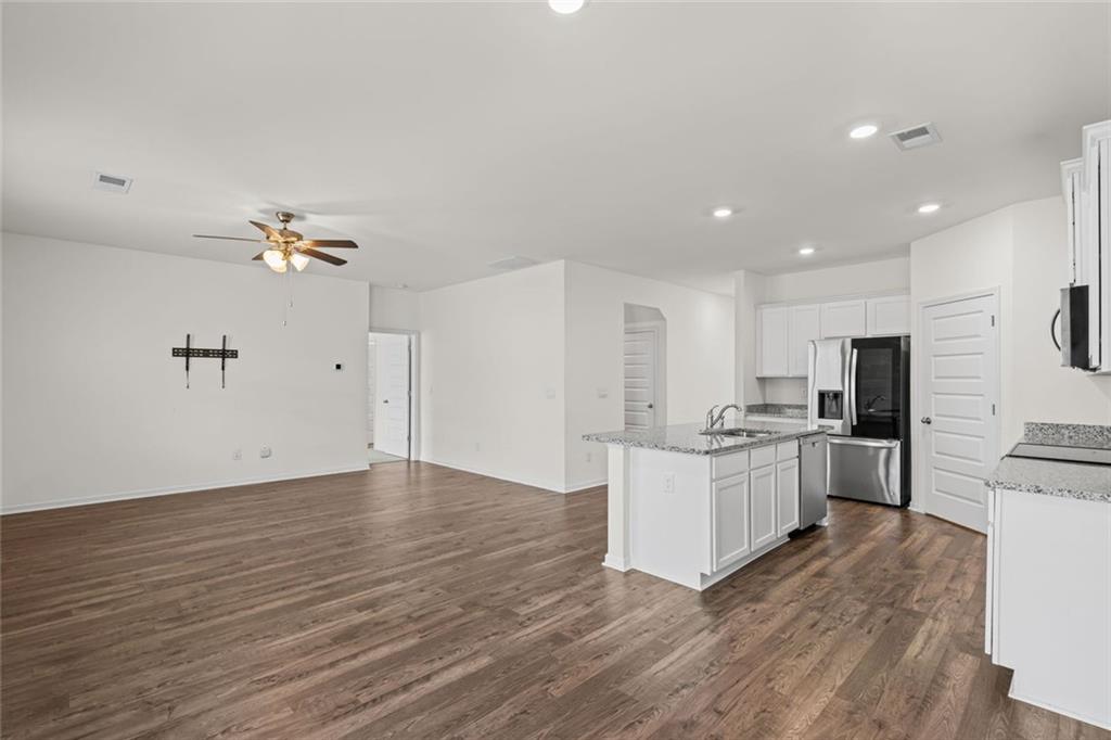 166 Champlain Road Hoschton, GA 30548 - Photo 14 of 53 a kitchen with kitchen island white cabinets and stainless steel appliances