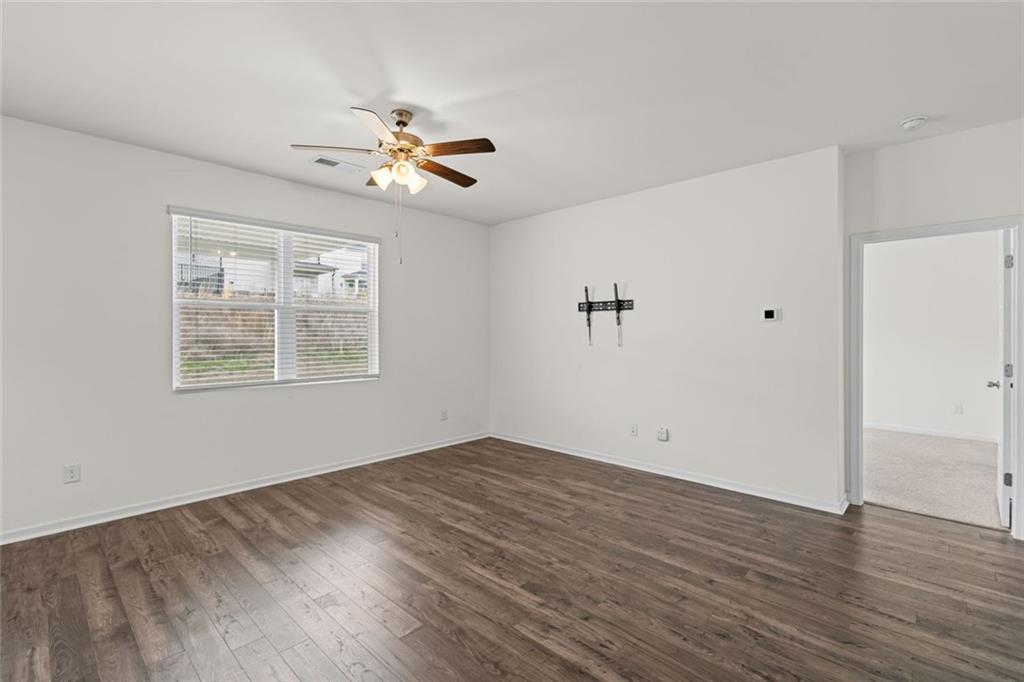 166 Champlain Road Hoschton, GA 30548 - Photo 15 of 53 a view of empty room with wooden floor and fan