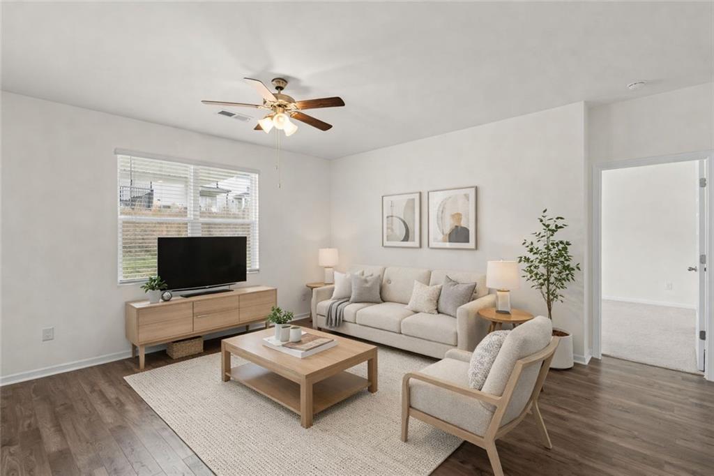 166 Champlain Road Hoschton, GA 30548 - Photo 16 of 53 a living room with furniture and a flat screen tv