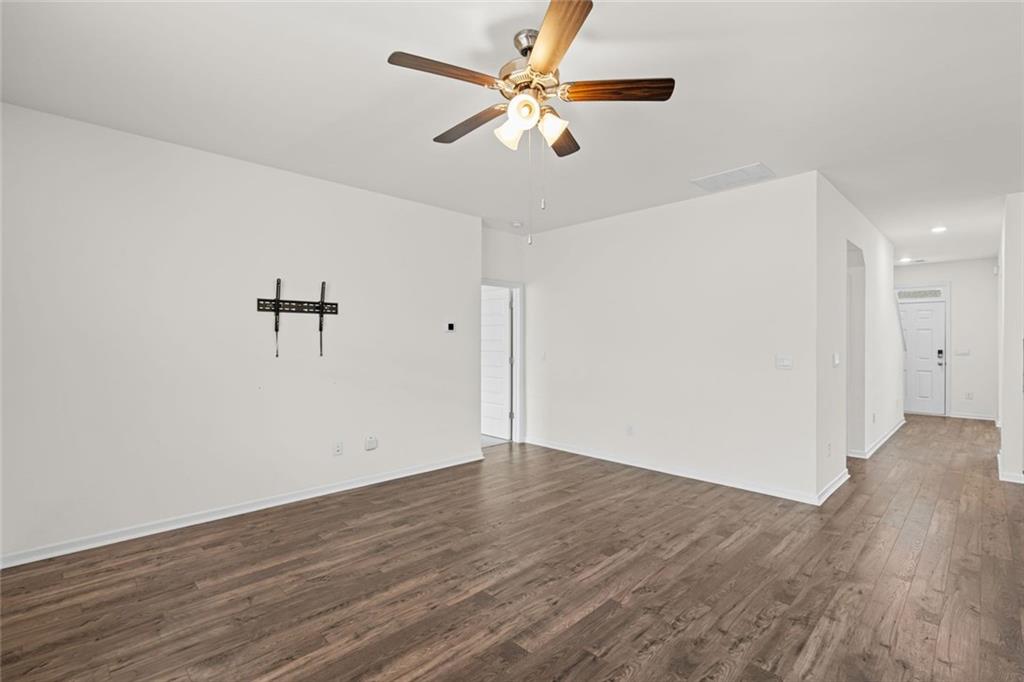166 Champlain Road Hoschton, GA 30548 - Photo 17 of 53 an empty room with wooden floor fan and windows