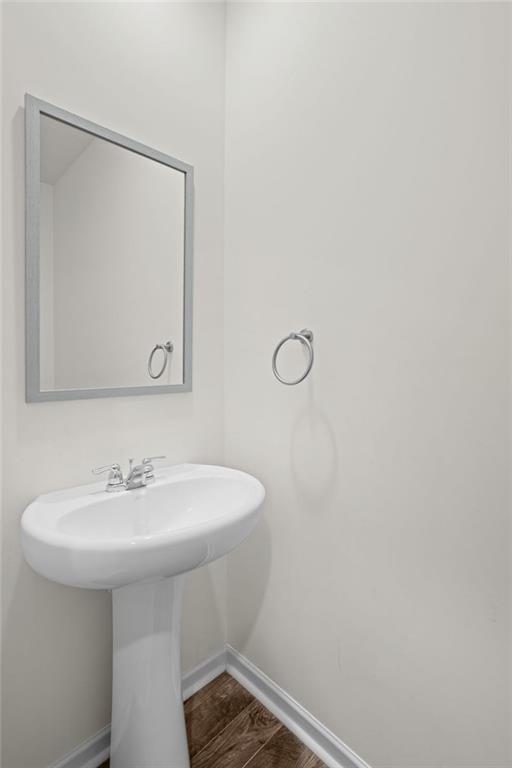 166 Champlain Road Hoschton, GA 30548 - Photo 18 of 53 a bathroom with a sink a mirror and a toilet