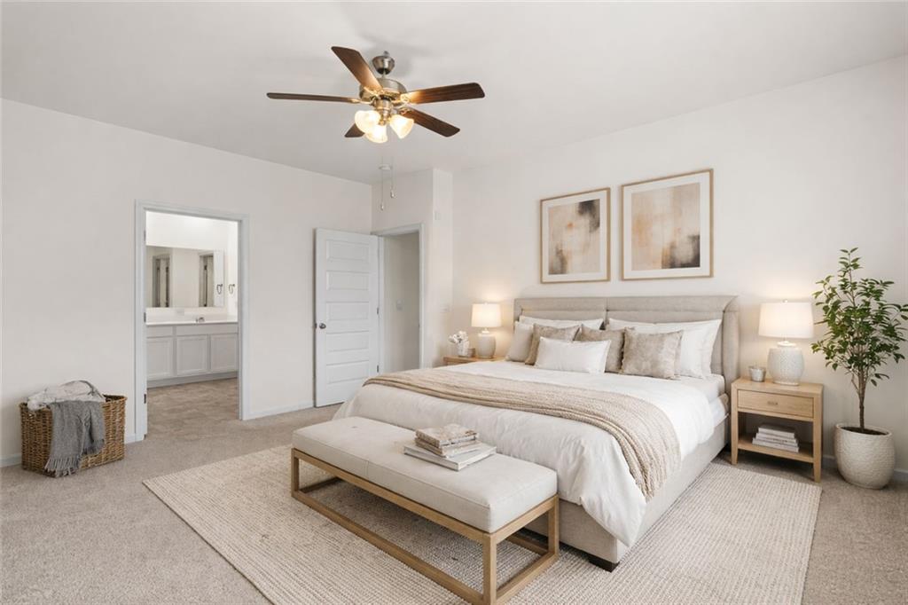 166 Champlain Road Hoschton, GA 30548 - Photo 19 of 53 a bedroom with a bed and a chandelier