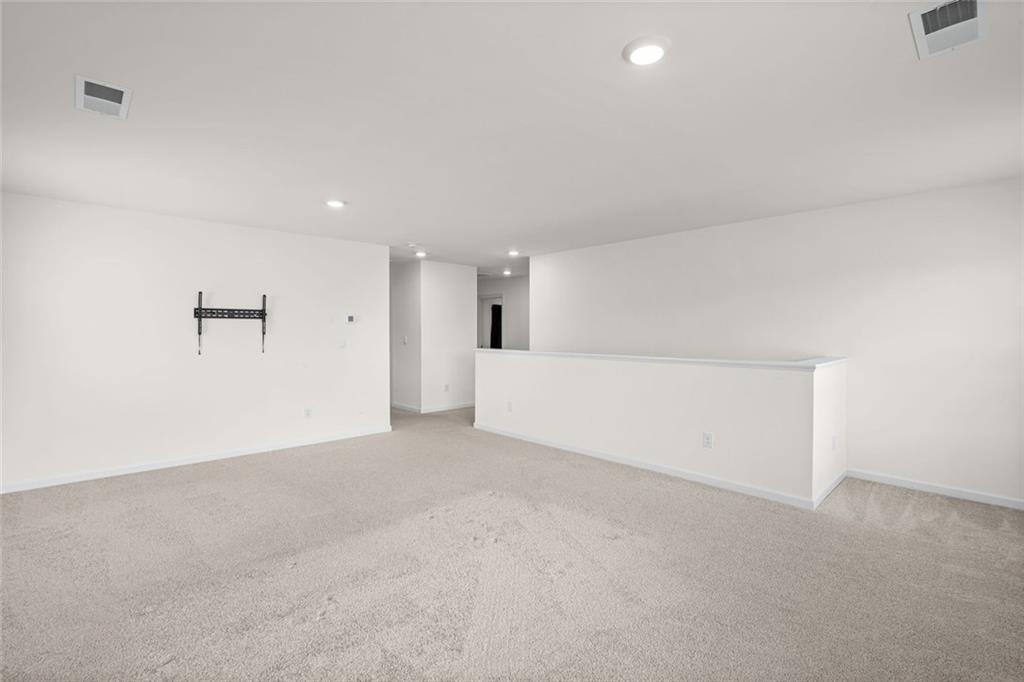 166 Champlain Road Hoschton, GA 30548 - Photo 25 of 53 an empty room with white wall and windows