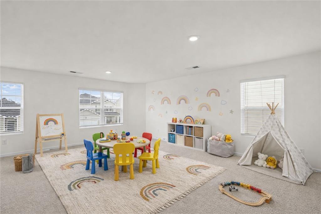 166 Champlain Road Hoschton, GA 30548 - Photo 26 of 53 a view of a dining room with furniture and a livingroom
