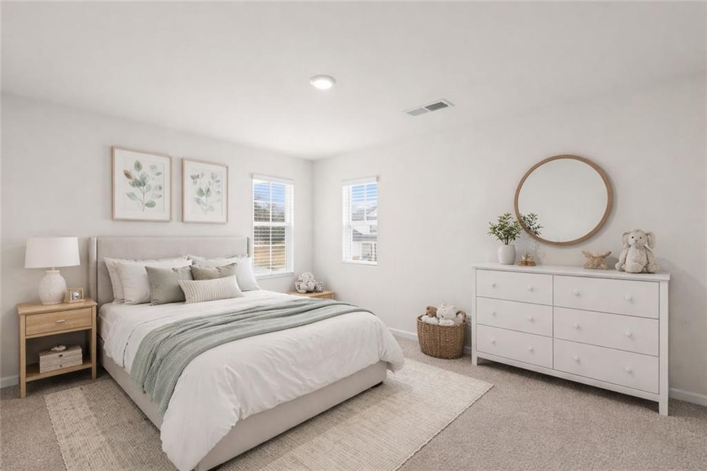 166 Champlain Road Hoschton, GA 30548 - Photo 28 of 53 a bedroom with a bed a mirror and wall painting