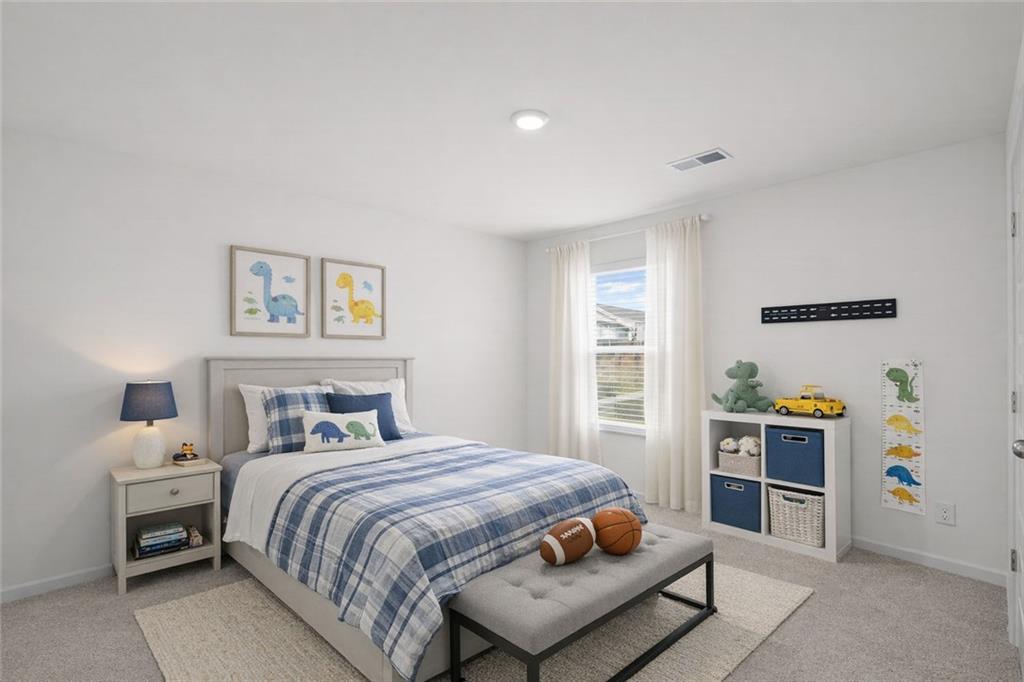 166 Champlain Road Hoschton, GA 30548 - Photo 30 of 53 a bedroom with a bed and a window