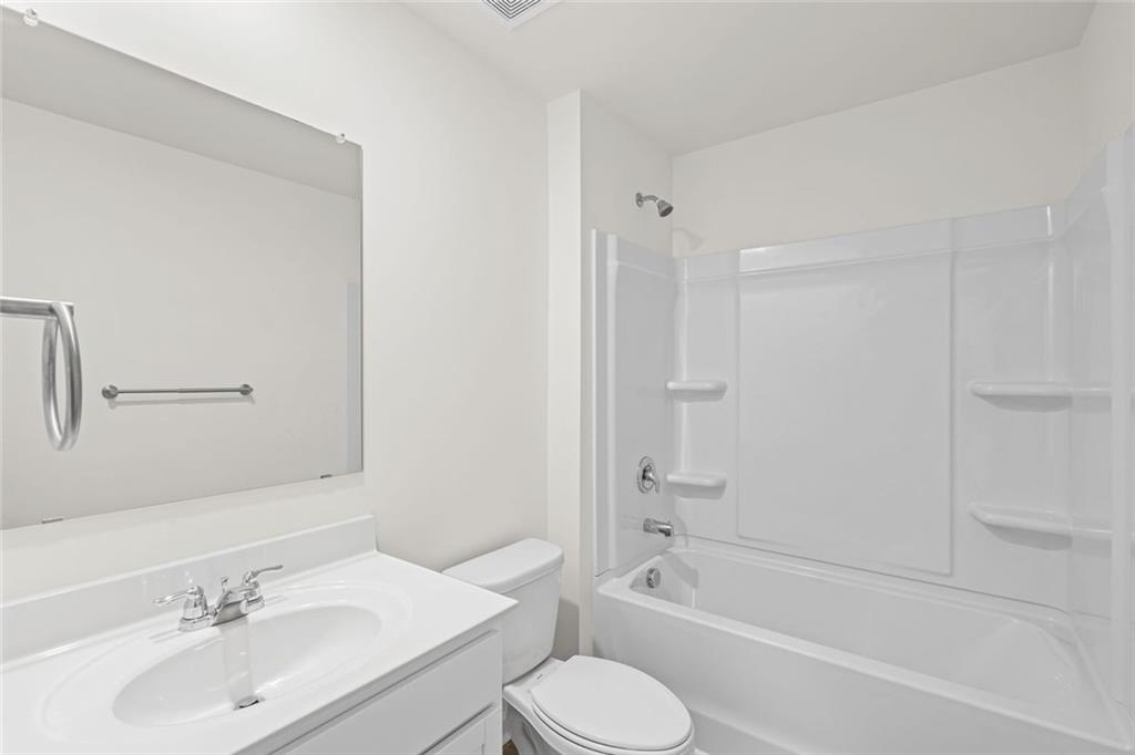166 Champlain Road Hoschton, GA 30548 - Photo 37 of 53 a bathroom with a sink toilet tub and vanity