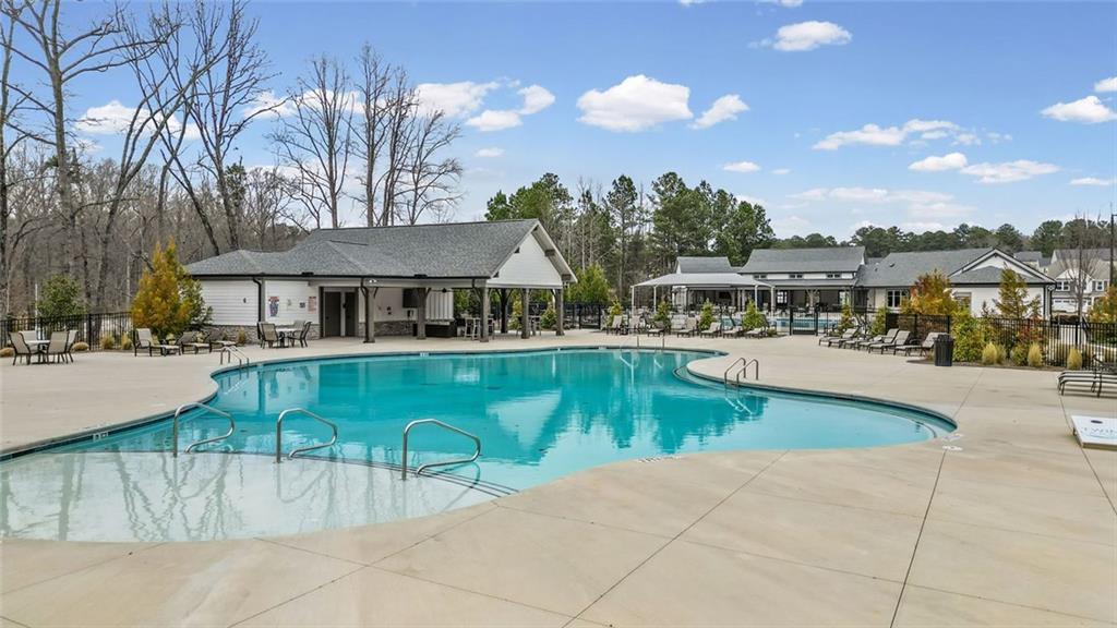 166 Champlain Road Hoschton, GA 30548 - Photo 45 of 53 a view of a swimming pool with outdoor seating and plants