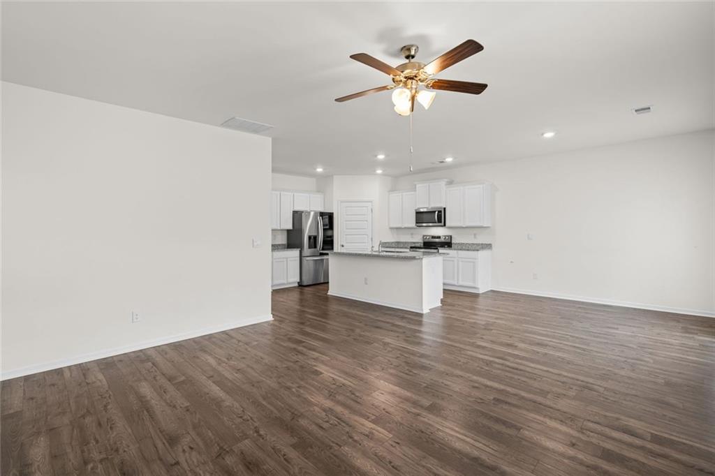166 Champlain Road Hoschton, GA 30548 - Photo 6 of 53 a view of kitchen with sink and wooden floor