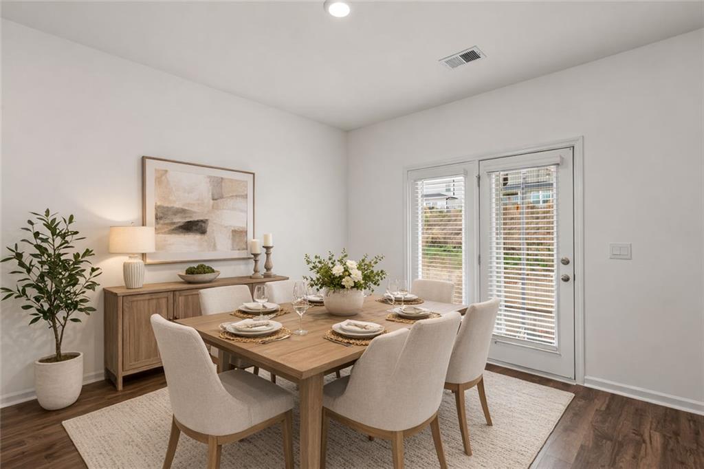 166 Champlain Road Hoschton, GA 30548 - Photo 8 of 53 a view of a dining room with furniture window and wooden floor