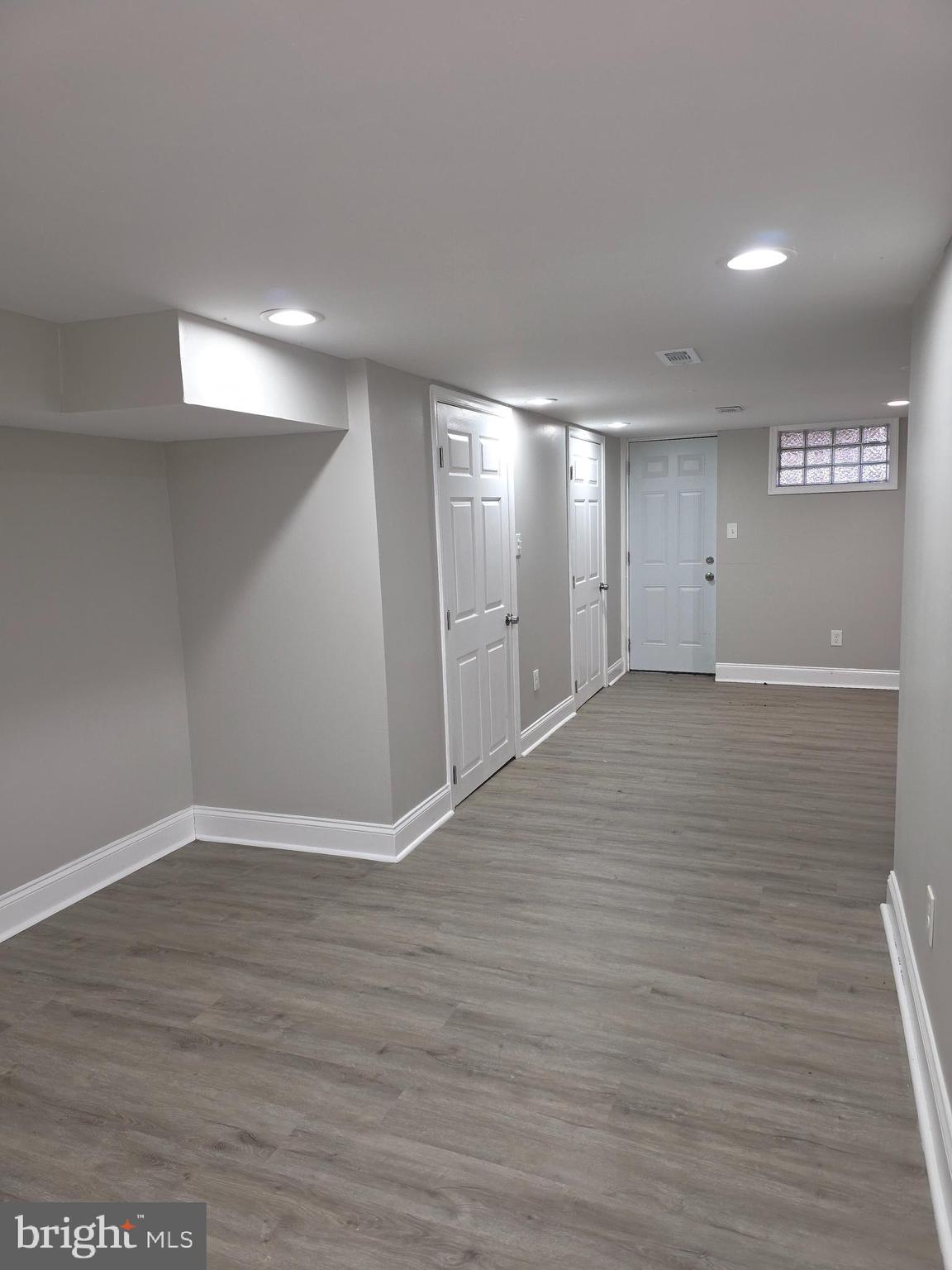 1042 Ellicott Driveway Baltimore, MD 21216 - Photo 13 of 13 a view of an empty room with wooden floor