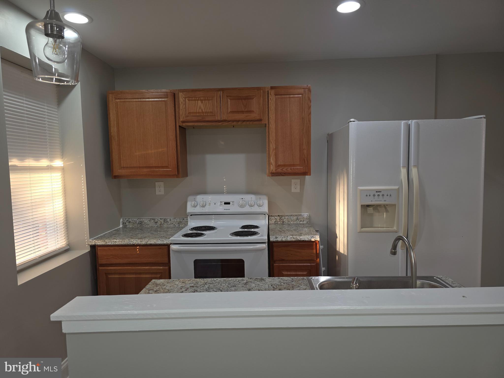 1042 Ellicott Driveway Baltimore, MD 21216 - Photo 2 of 13 a kitchen with a stove and a refrigerator