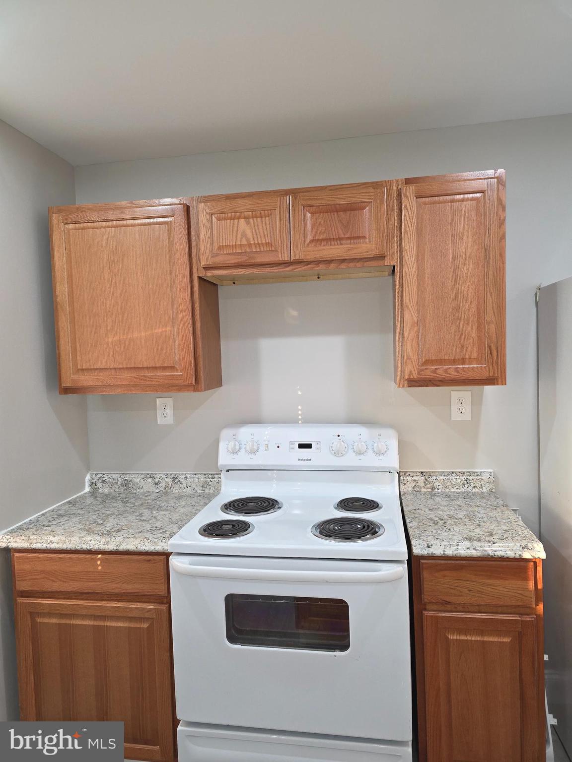1042 Ellicott Driveway Baltimore, MD 21216 - Photo 3 of 13 a kitchen with a stove and a microwave