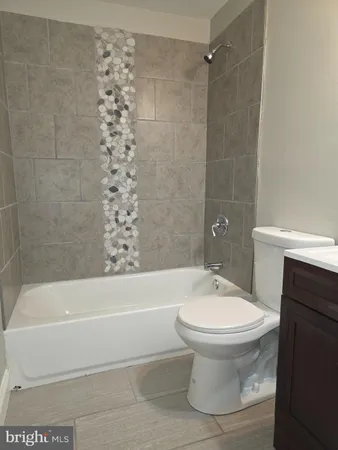 a bathroom with a white toilet and sink