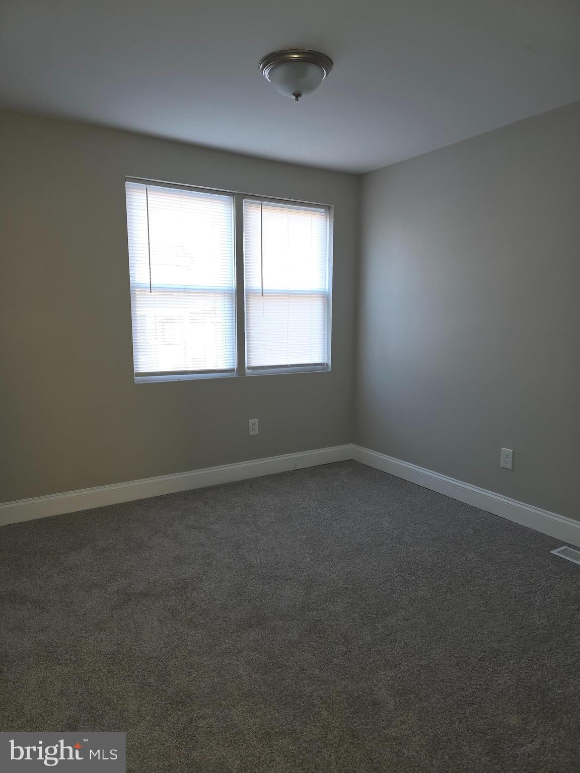 1042 Ellicott Driveway Baltimore, MD 21216 - Photo 9 of 13 an empty room with a window