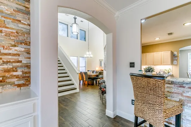 a view of a hallway with furniture and wooden floor