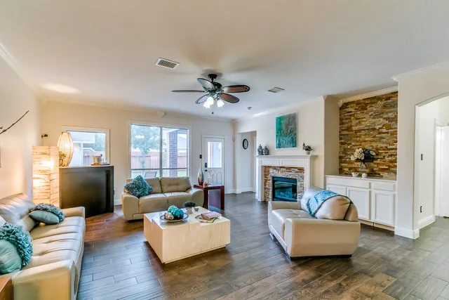 a living room with furniture fireplace and a large window