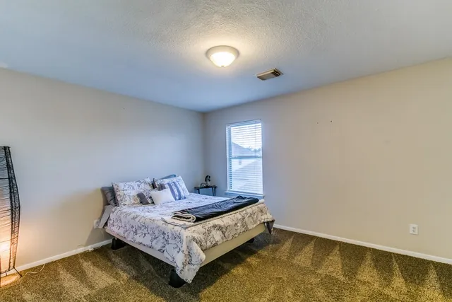 a bedroom with a bed and window