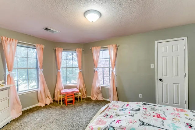 a bedroom with bed and a window