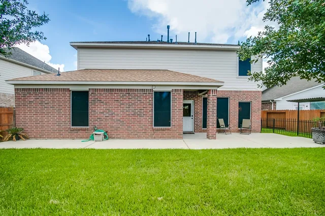 a front view of a house with a garden and plants