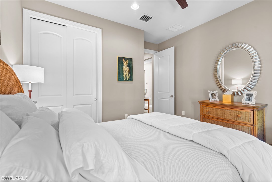 20198 Corkscrew Shores Boulevard Estero, FL 33928 - Photo 11 of 50 a bedroom with a bed and a mirror