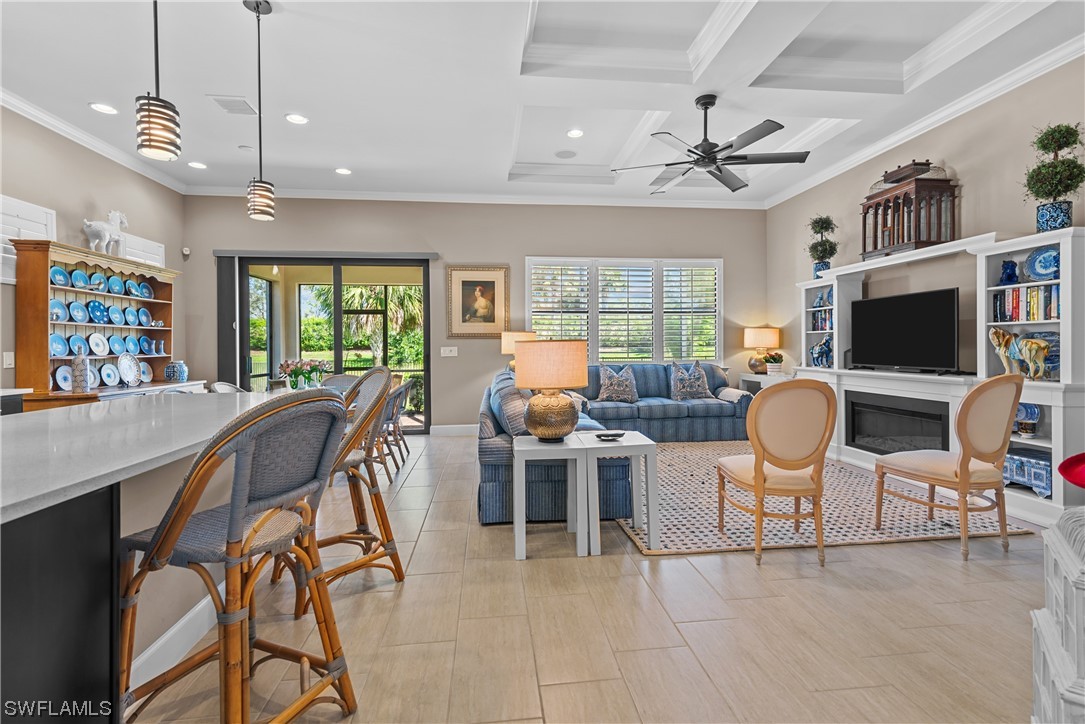 20198 Corkscrew Shores Boulevard Estero, FL 33928 - Photo 12 of 50 a living room with furniture a flat screen tv and kitchen view