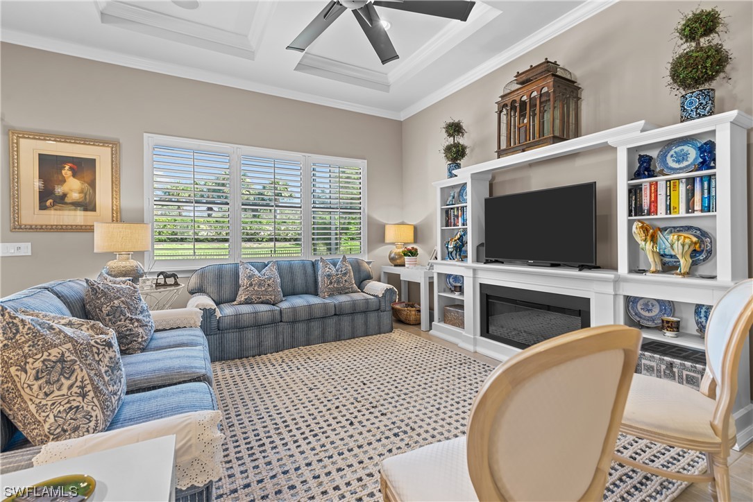 20198 Corkscrew Shores Boulevard Estero, FL 33928 - Photo 13 of 50 a living room with furniture a flat screen tv and a fireplace