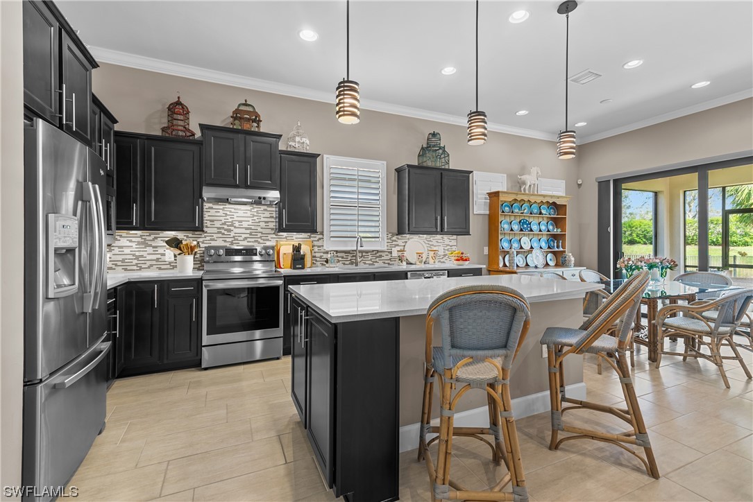 20198 Corkscrew Shores Boulevard Estero, FL 33928 - Photo 16 of 50 a kitchen with stainless steel appliances granite countertop a sink a stove and a refrigerator
